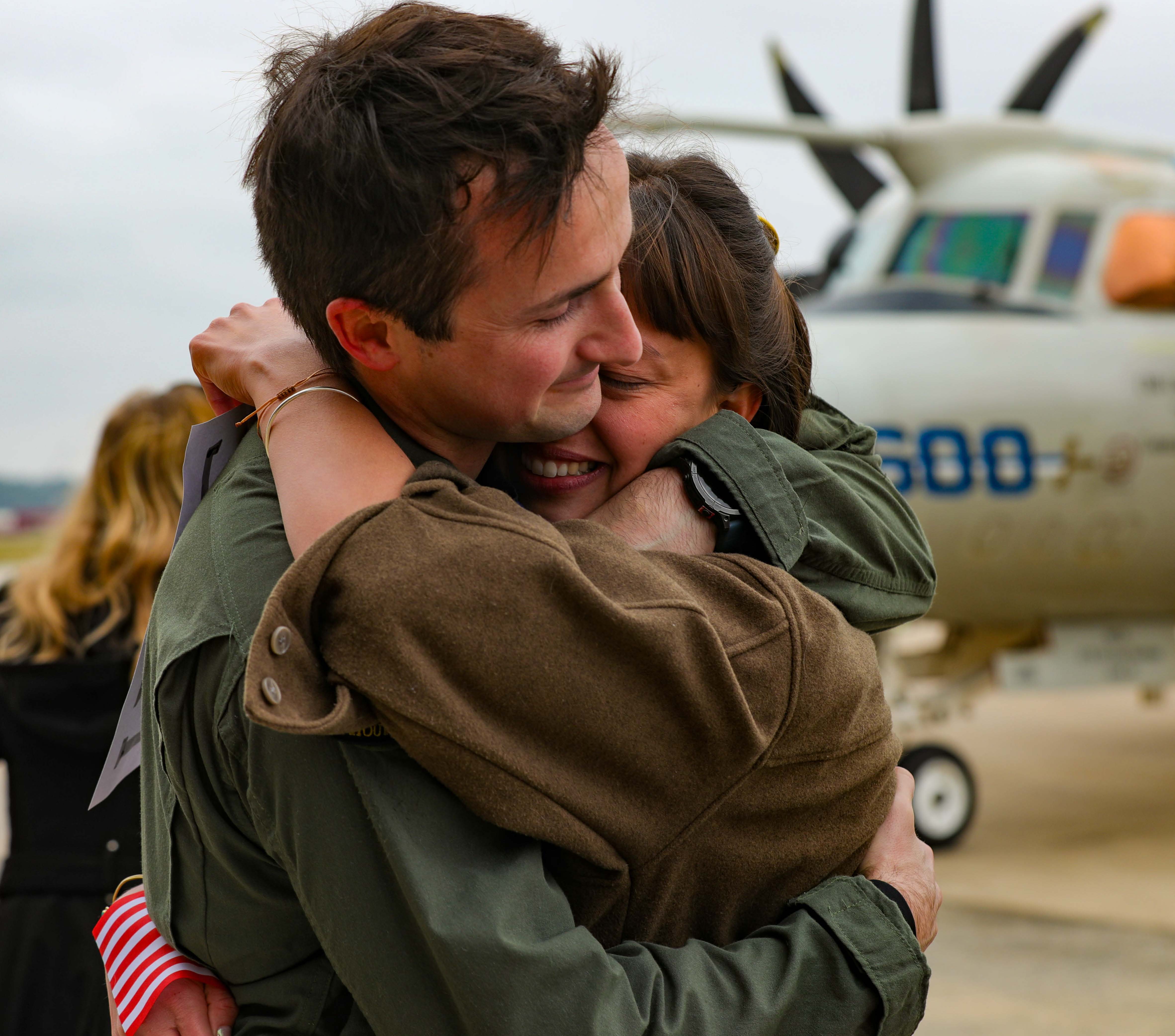 Coast Guard sailor with wife and 2 kids at port