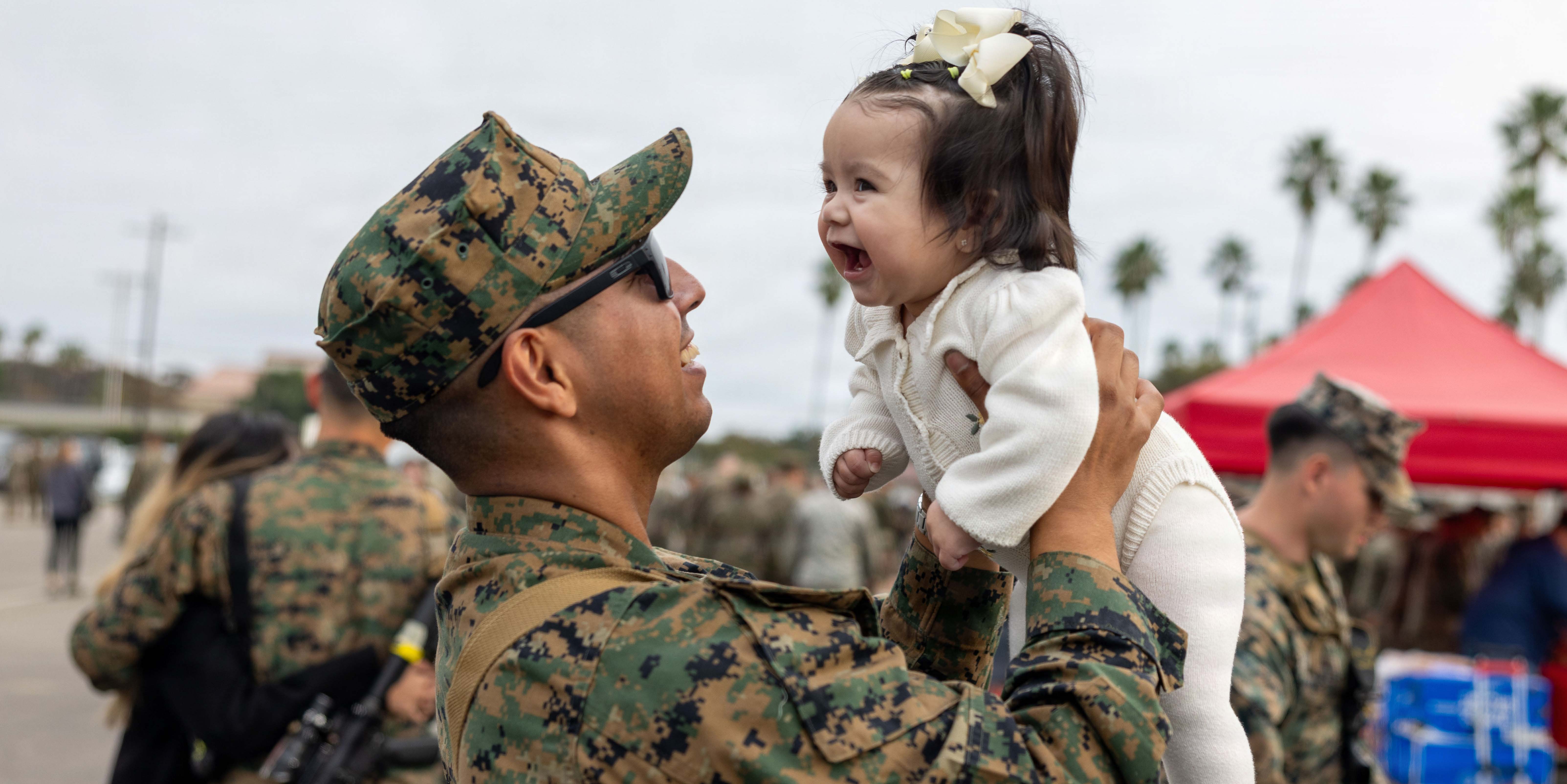 Soldiers standing around children giving them high-fives
