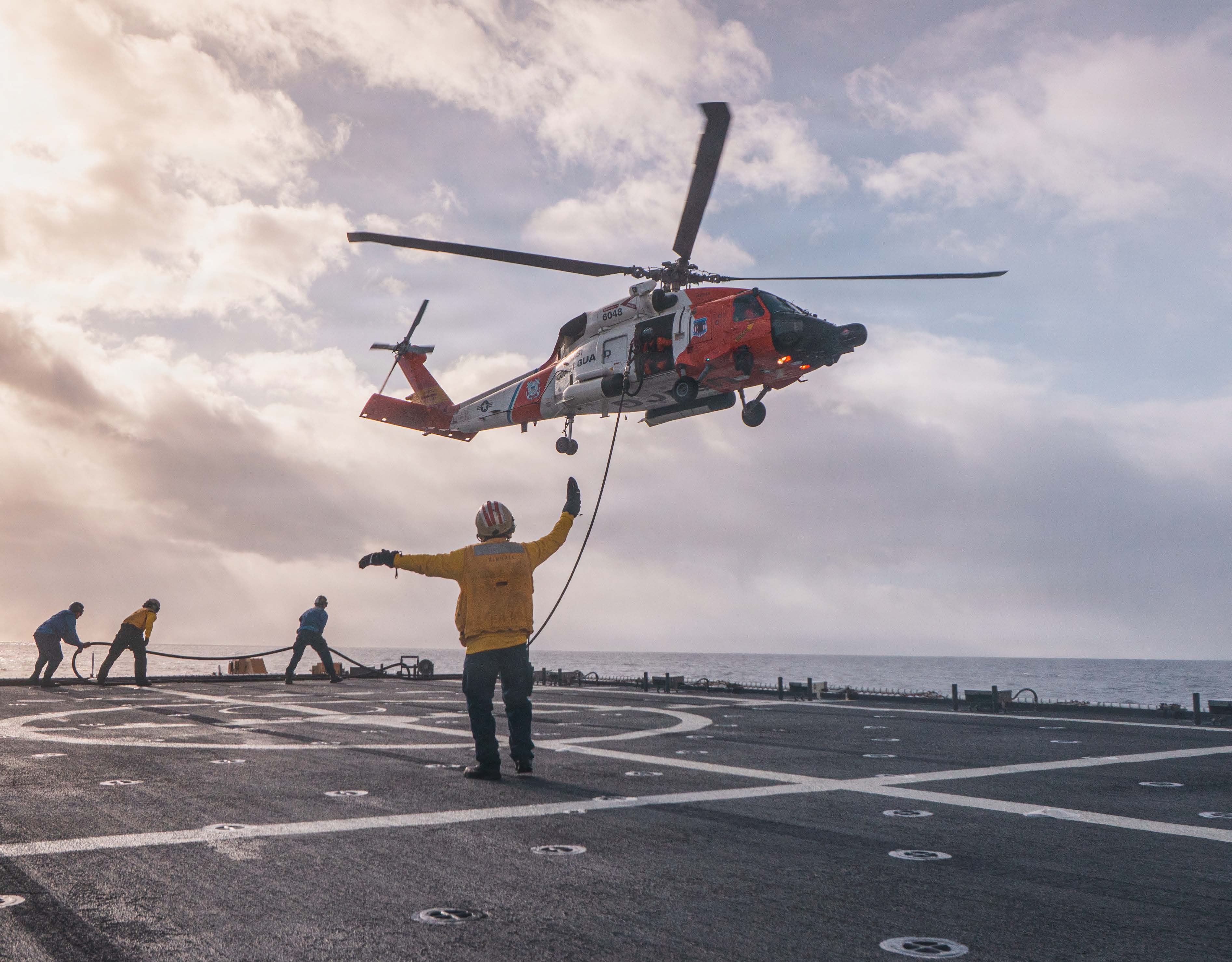 Navy sailor doing squats on a weight bench